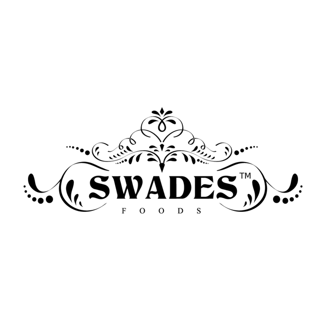 The black and white logo for Swades Foods, featuring an ornate decorative crest above the brand name in a bold serif font, with 'FOODS' written in smaller capital letters underneath, all on a solid white background.